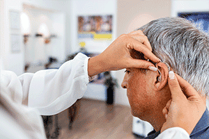Man getting fitted with hearing aids